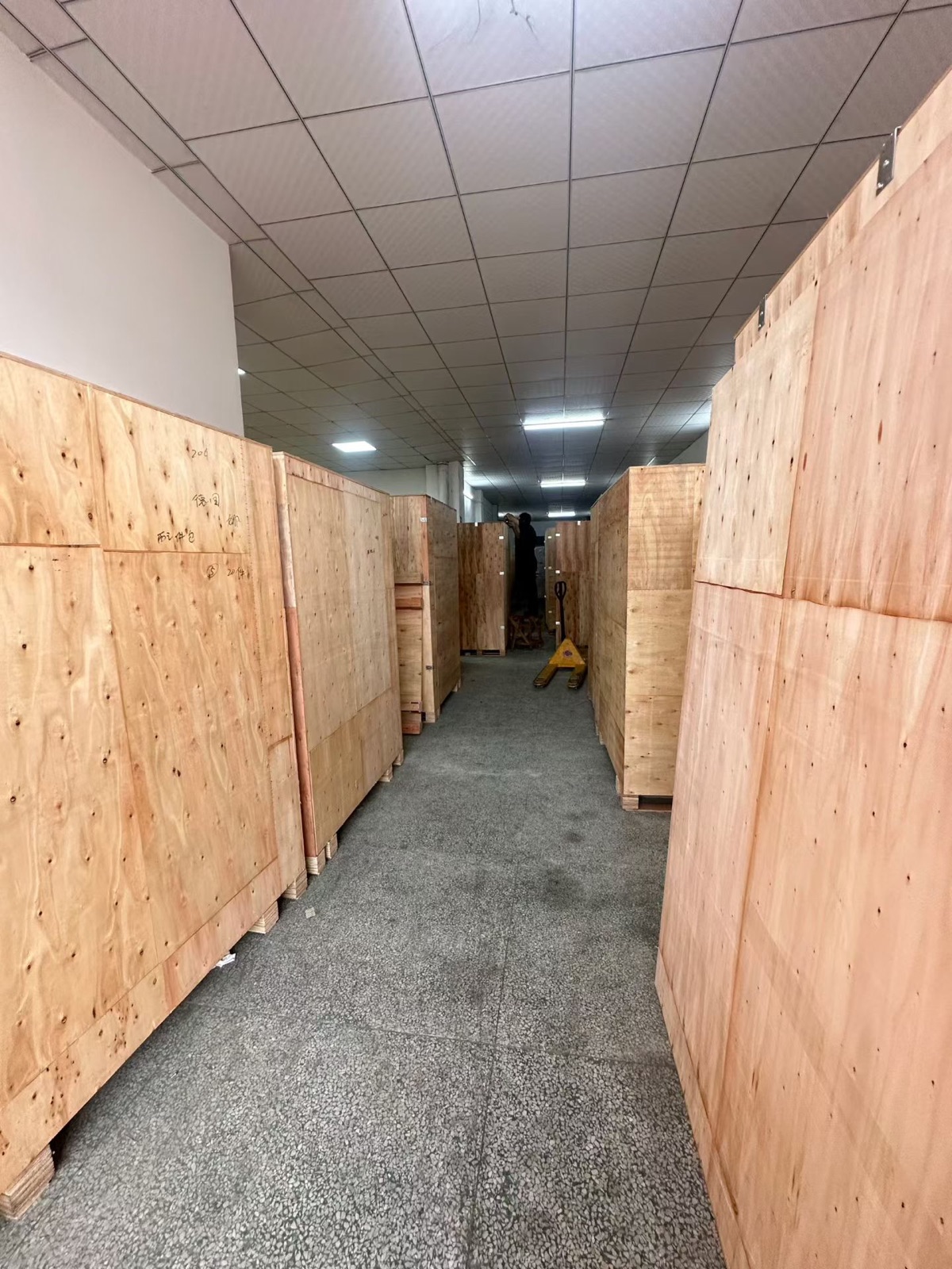 Wooden export crates in the Red Rabbit machine packing area in August 2026